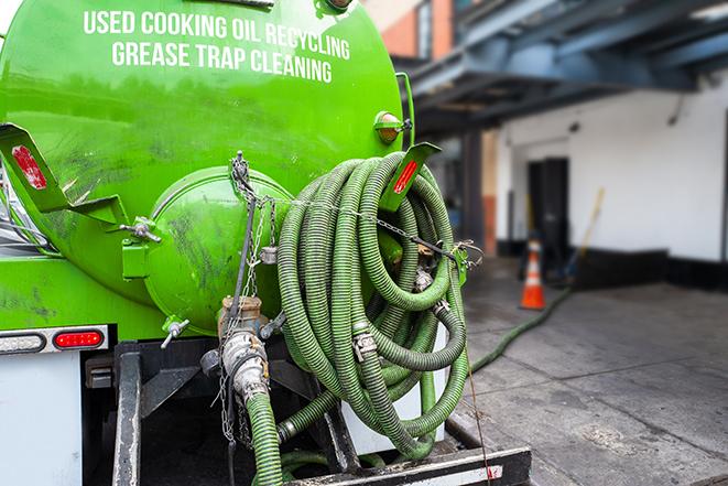 a large grease trap being pumped by a specialist in Des Plaines